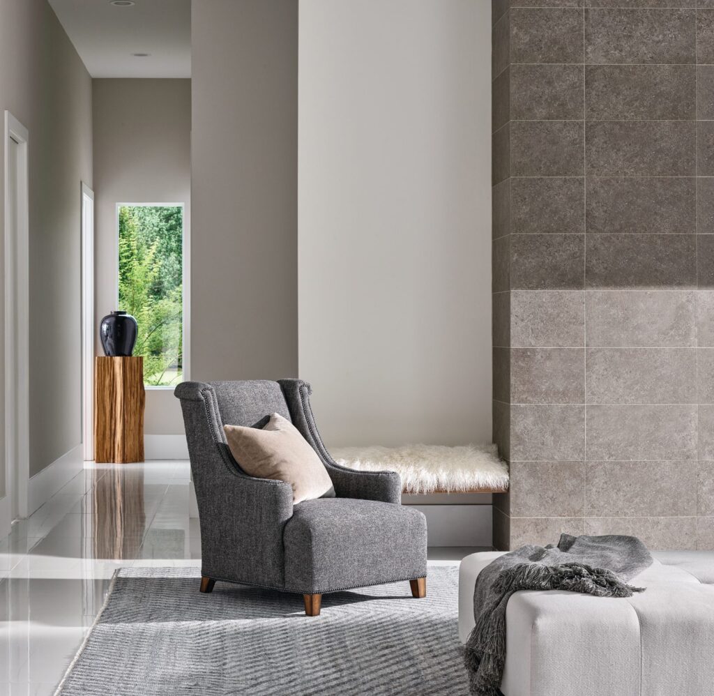 Henry wing chair in heathered charcoal tweed with tapered legs in a modern gray hallway