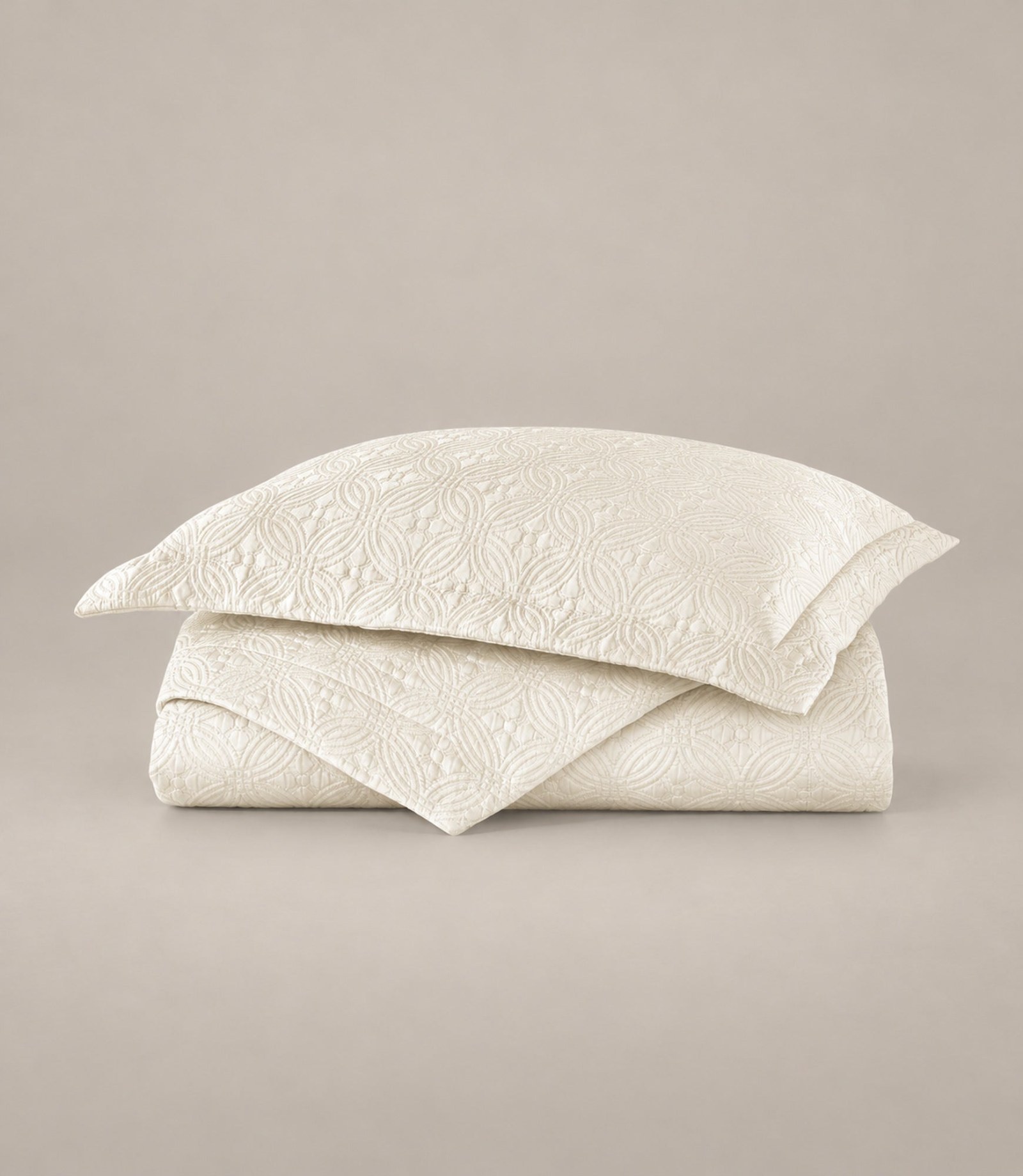 Peacock Alley Lucia matelassé coverlet in pearl, folded and stacked