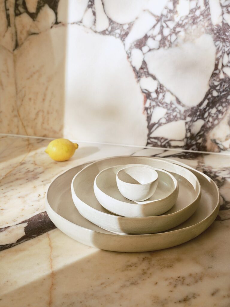 Rita Konig Household Goods white nesting platters on a marble counter