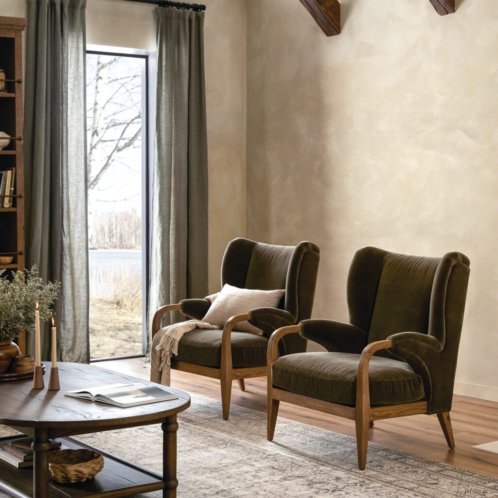 Pair of Sedoni lounge chairs in olive velvet with warm oak arms and legs in a sitting room with linen drapery