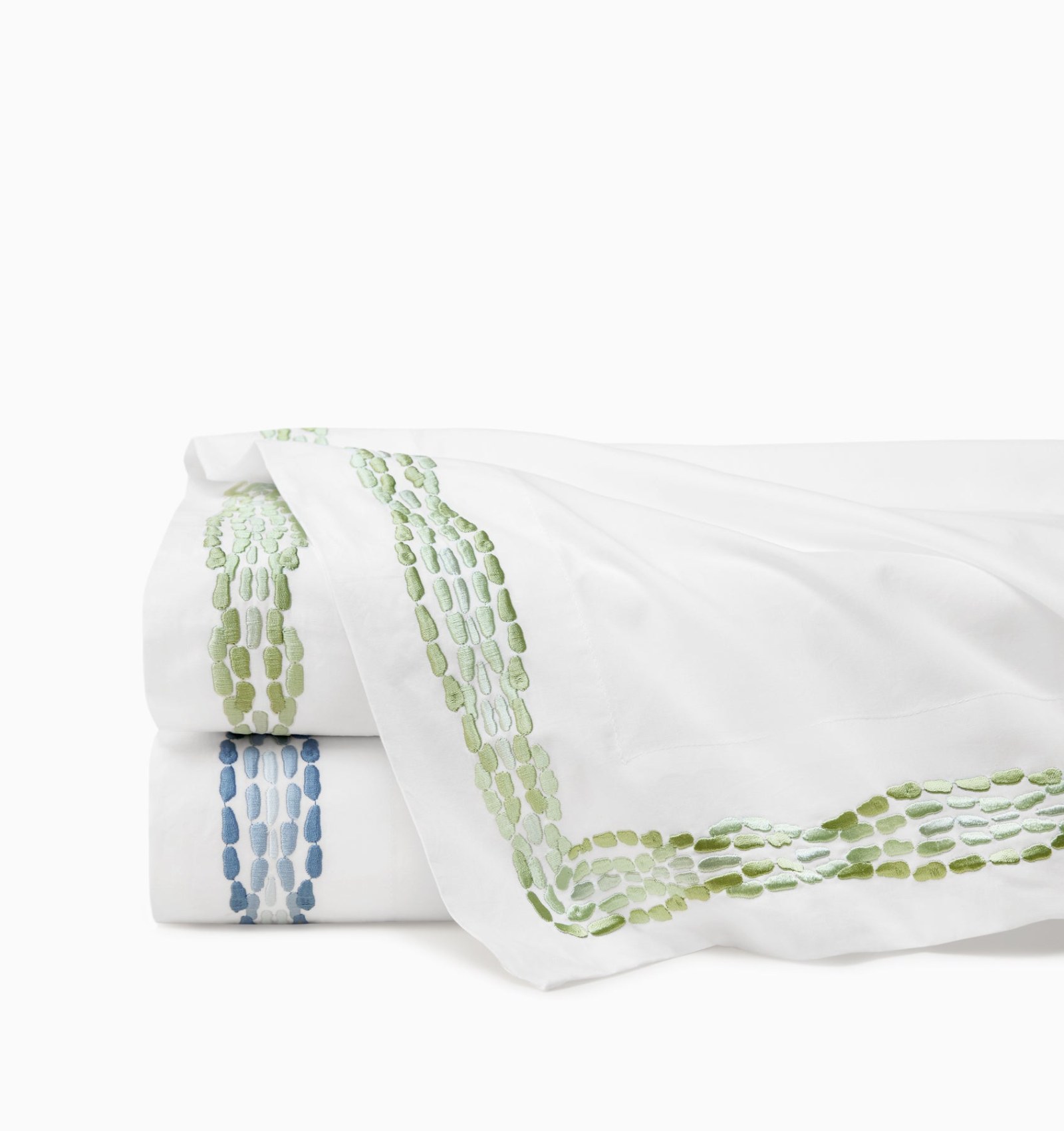 Sferra Cobblestones embroidered flat sheets from the Scalamandré collection, stacked